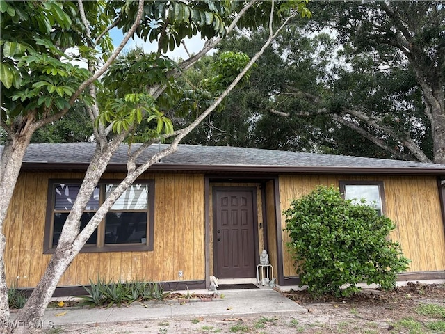 2325 55th Ter SW, Naples, FL 34116 - view of exterior entry with roof with shingles