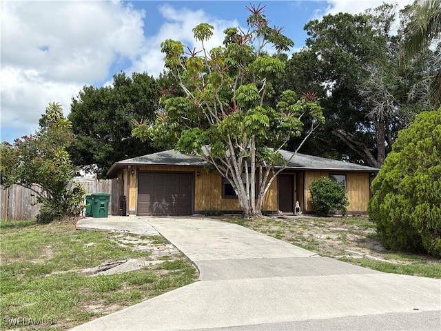 2325 55th Ter SW, Naples, FL 34116 - view of front of house featuring an attached garage and concrete driveway