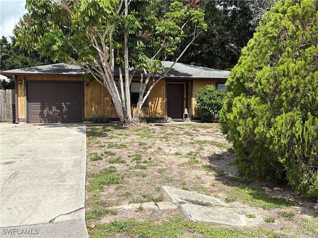 2325 55th Ter SW, Naples, FL 34116 - view of front facade featuring an attached garage and concrete driveway