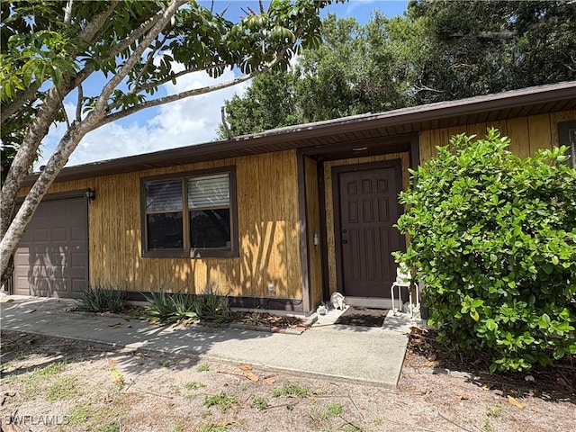2325 55th Ter SW, Naples, FL 34116 - doorway to property featuring a garage