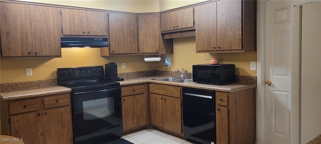 2325 55th Ter SW, Naples, FL 34116 - kitchen featuring black appliances, under cabinet range hood, light tile patterned flooring, and brown cabinetry