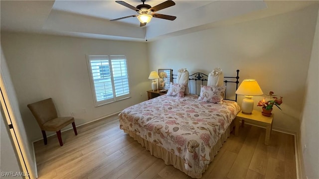 10041 Lake Cove Dr Unit 202, Fort Myers, FL 33908 - bedroom with a tray ceiling, light wood-style flooring, and a ceiling fan