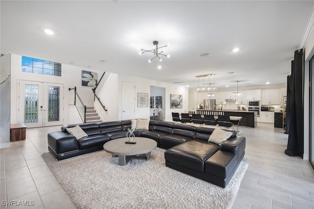 19477 The Place Blvd, Estero, FL 33928 - living area with stairs, a chandelier, recessed lighting, french doors, and light tile patterned floors