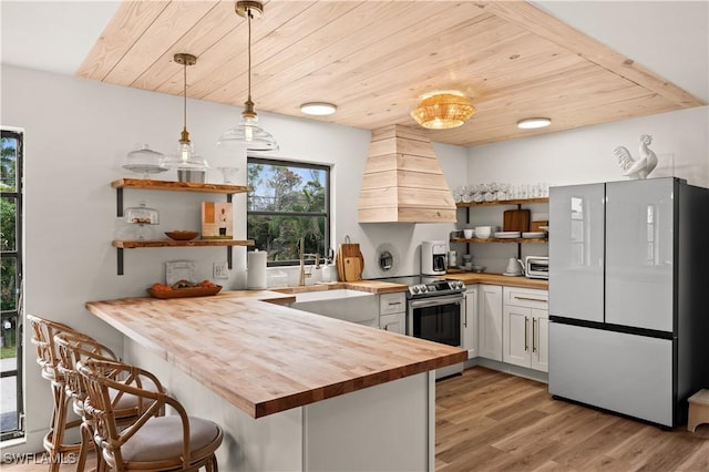 4805 Gary Rd, Bonita Springs, FL 34134 - kitchen featuring freestanding refrigerator, wooden counters, open shelves, stainless steel range with electric stovetop, and a peninsula