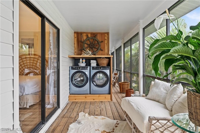 4805 Gary Rd, Bonita Springs, FL 34134 - laundry room featuring washing machine and clothes dryer, wood-type flooring, and wooden walls