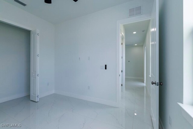 2501 26th St W, Lehigh Acres, FL 33971 - spare room featuring marble look tiles, ceiling fan, and recessed lighting