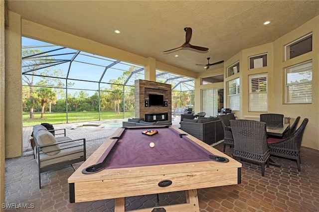1640 Golden Gate Blvd W, Naples, FL 34117 - view of patio with an outdoor living space with a fireplace, a jacuzzi, a lanai, and a ceiling fan
