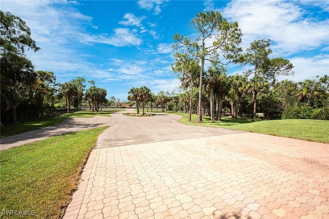 1640 Golden Gate Blvd W, Naples, FL 34117 - view of community featuring a yard, driveway, and view of wooded area