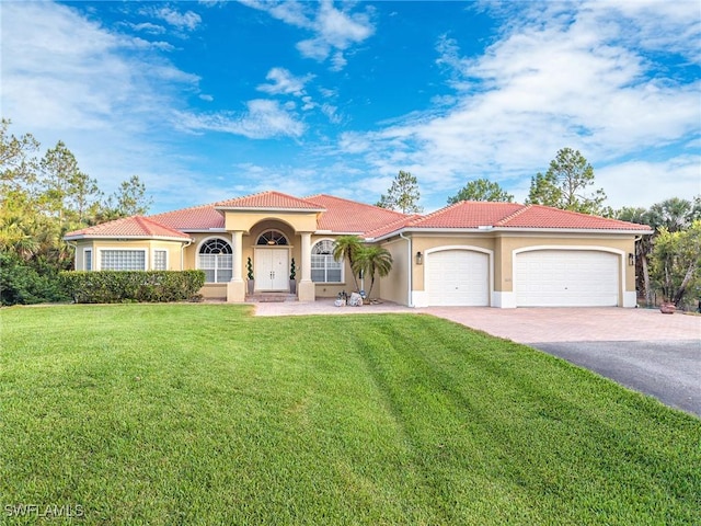 1640 Golden Gate Blvd W, Naples, FL 34117 - mediterranean / spanish-style home with stucco siding, a garage, driveway, a front yard, and a tiled roof