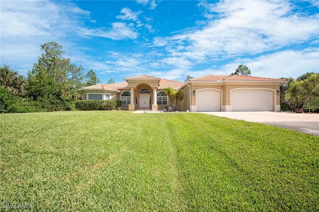 1640 Golden Gate Blvd W, Naples, FL 34117 - mediterranean / spanish-style house featuring an attached garage, concrete driveway, a front yard, stucco siding, and a tile roof