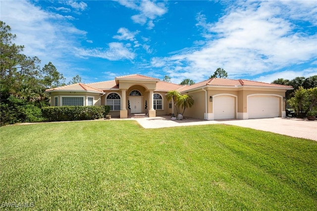 1640 Golden Gate Blvd W, Naples, FL 34117 - mediterranean / spanish-style home with an attached garage, driveway, a tile roof, stucco siding, and a front yard
