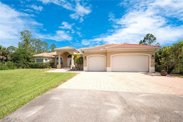 1640 Golden Gate Blvd W, Naples, FL 34117 - mediterranean / spanish-style house with stucco siding, decorative driveway, a front lawn, an attached garage, and a tiled roof
