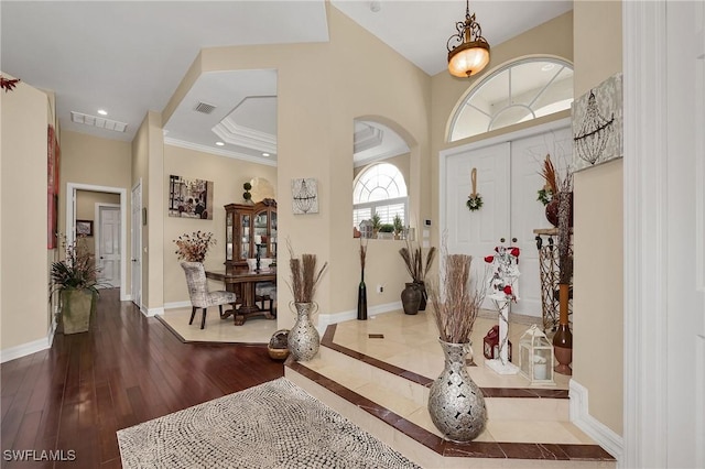 1640 Golden Gate Blvd W, Naples, FL 34117 - entryway with dark wood-style flooring, crown molding, arched walkways, and recessed lighting