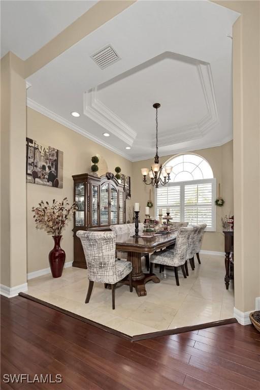 1640 Golden Gate Blvd W, Naples, FL 34117 - dining area with light wood finished floors, a tray ceiling, a chandelier, crown molding, and recessed lighting