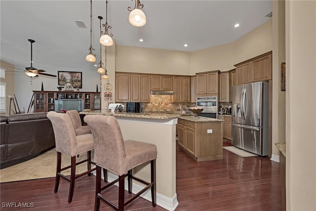 1640 Golden Gate Blvd W, Naples, FL 34117 - kitchen with stainless steel appliances, under cabinet range hood, decorative backsplash, a ceiling fan, and dark wood-style flooring