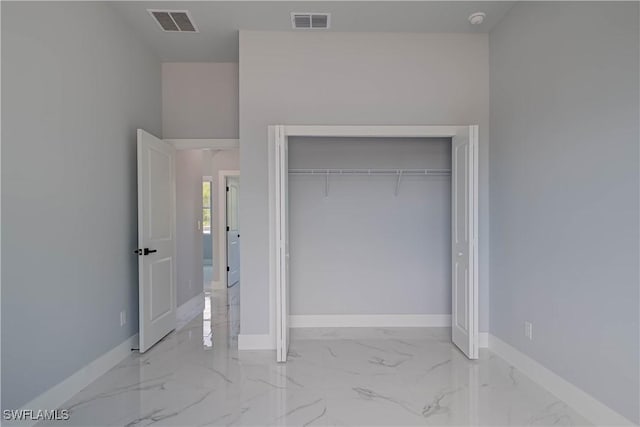 3417 71st St W, Lehigh Acres, FL 33971 - unfurnished bedroom with marble finish flooring, baseboards, and a closet