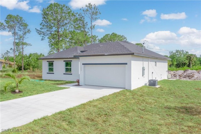 3417 71st St W, Lehigh Acres, FL 33971 - view of front facade with stucco siding, driveway, a front lawn, a garage, and a shingled roof