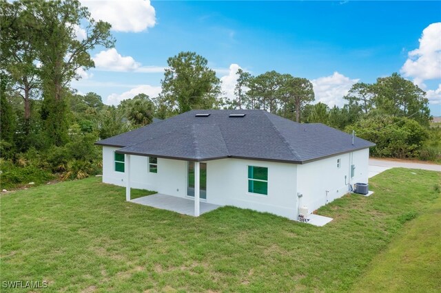 3417 71st St W, Lehigh Acres, FL 33971 - back of house with a yard, a patio area, and roof with shingles
