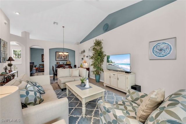 28220 Caballero Way Unit 2422, Bonita Springs, FL 34135 - living area featuring a chandelier, arched walkways, high vaulted ceiling, and wood finished floors