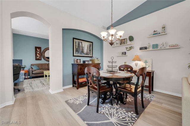 28220 Caballero Way Unit 2422, Bonita Springs, FL 34135 - dining room with wood finished floors, a chandelier, arched walkways, lofted ceiling, and baseboards