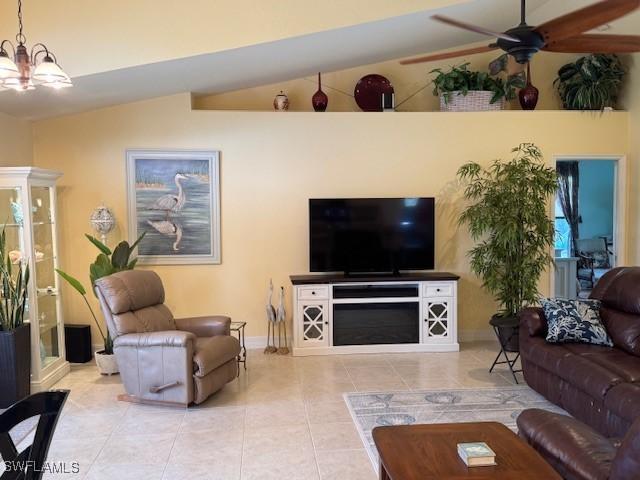 1505 NW 33rd Pl, Cape Coral, FL 33993 - tiled living area featuring a chandelier, ceiling fan, and vaulted ceiling
