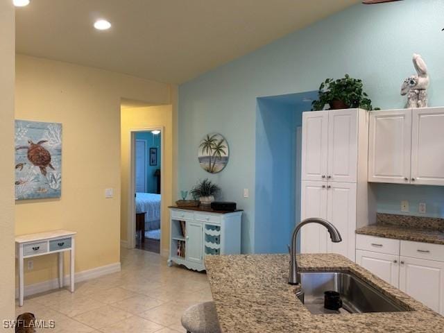 1505 NW 33rd Pl, Cape Coral, FL 33993 - kitchen with stone counters, white cabinets, lofted ceiling, recessed lighting, and light tile patterned flooring