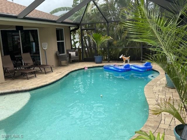 1505 NW 33rd Pl, Cape Coral, FL 33993 - outdoor pool featuring a patio and a lanai