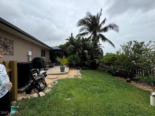1505 NW 33rd Pl, Cape Coral, FL 33993 - view of grassy yard featuring a patio area