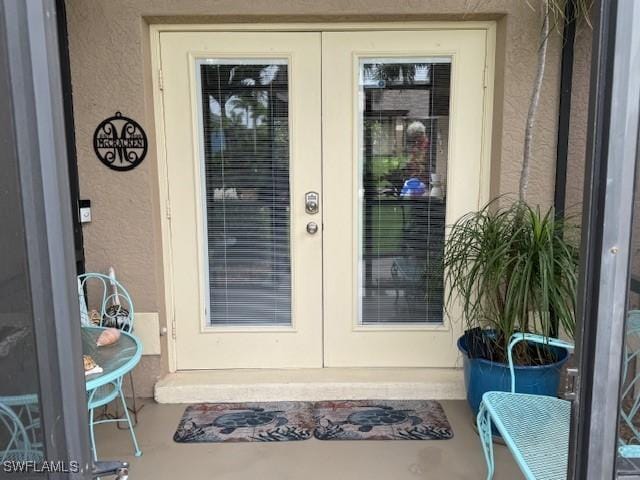 1505 NW 33rd Pl, Cape Coral, FL 33993 - doorway to property featuring french doors and stucco siding