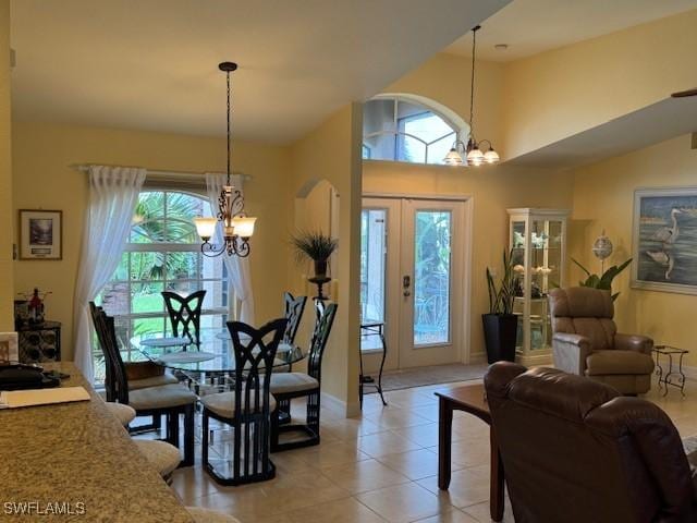 1505 NW 33rd Pl, Cape Coral, FL 33993 - dining area featuring a chandelier, arched walkways, and light tile patterned floors