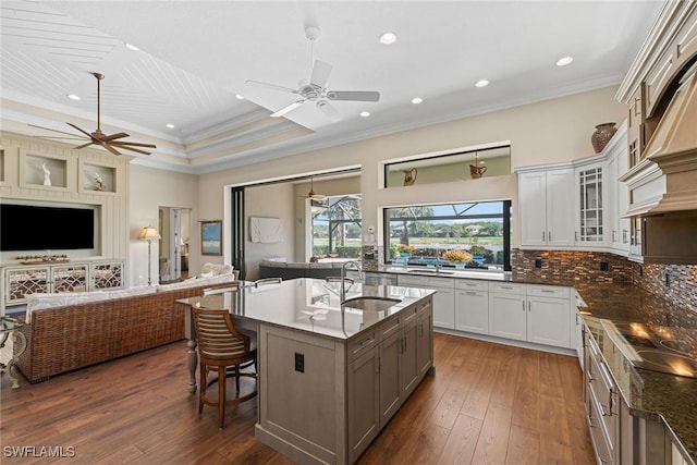 11950 Heather Woods Ct, Naples, FL 34120 - kitchen with a sink, a ceiling fan, open floor plan, crown molding, and glass insert cabinets