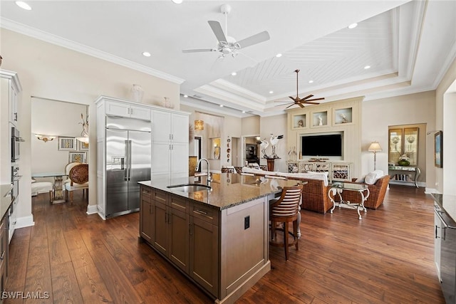 11950 Heather Woods Ct, Naples, FL 34120 - kitchen featuring appliances with stainless steel finishes, a ceiling fan, a raised ceiling, a sink, and dark wood finished floors