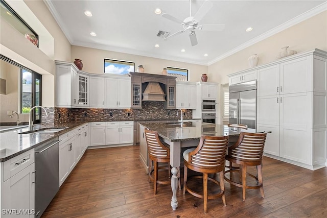 11950 Heather Woods Ct, Naples, FL 34120 - kitchen featuring appliances with stainless steel finishes, a sink, ornamental molding, decorative backsplash, and a ceiling fan
