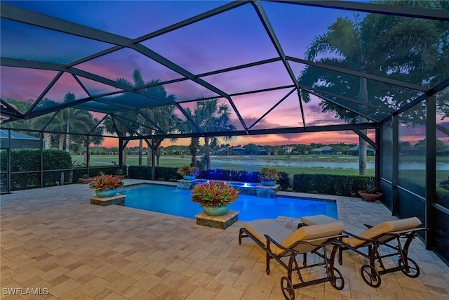 11950 Heather Woods Ct, Naples, FL 34120 - pool at dusk featuring an outdoor pool, a water view, a hot tub, and a patio area