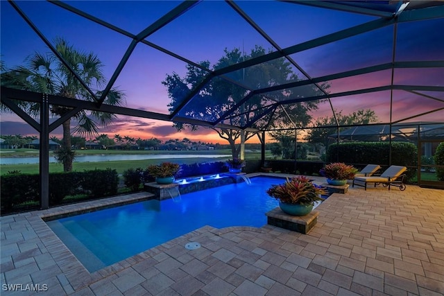 11950 Heather Woods Ct, Naples, FL 34120 - pool at dusk featuring a patio area, a water view, a pool with connected hot tub, and a lanai