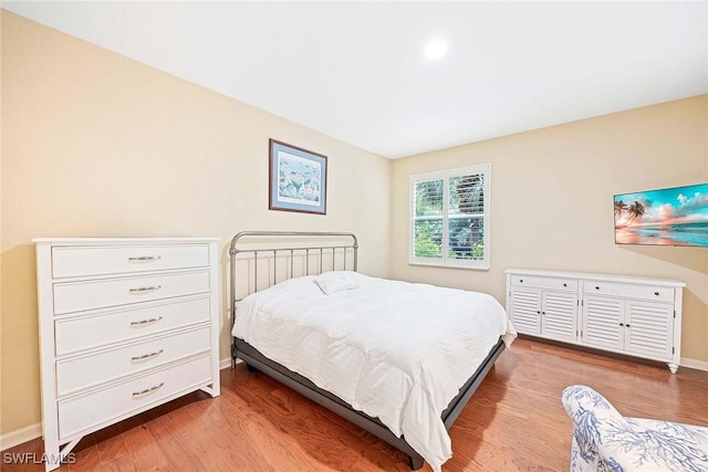 6637 Alden Woods Cir Unit 102, Naples, FL 34113 - bedroom with light wood-type flooring and baseboards
