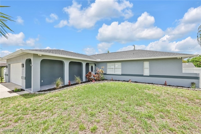 628 SW 9th Ave, Cape Coral, FL 33991 - view of front facade with an attached garage, stucco siding, a front lawn, and driveway
