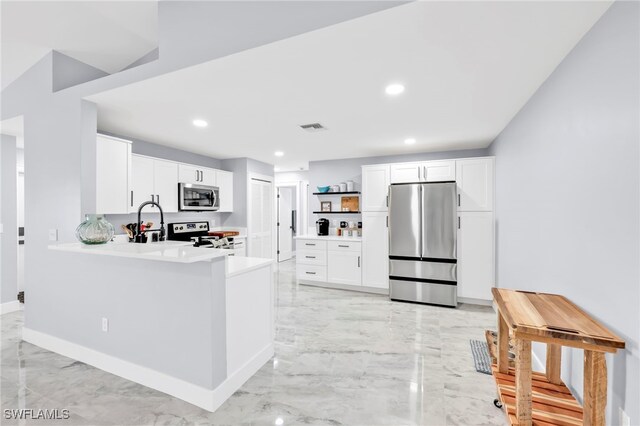 628 SW 9th Ave, Cape Coral, FL 33991 - kitchen with stainless steel appliances, open shelves, light marble finish flooring, light countertops, and recessed lighting