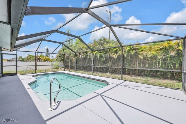 628 SW 9th Ave, Cape Coral, FL 33991 - outdoor pool featuring a patio area, a fenced backyard, and glass enclosure