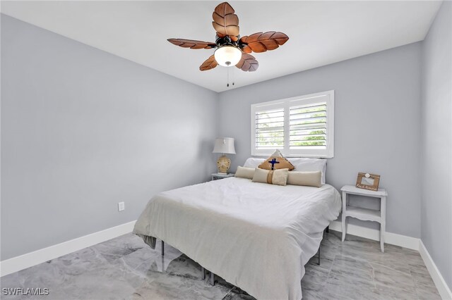 628 SW 9th Ave, Cape Coral, FL 33991 - bedroom featuring baseboards, ceiling fan, and light marble finish floors
