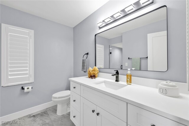 628 SW 9th Ave, Cape Coral, FL 33991 - bathroom featuring marble look tiles, vanity, baseboards, and toilet