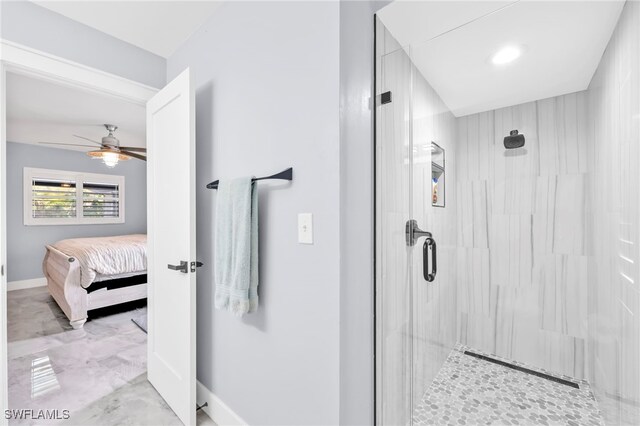 628 SW 9th Ave, Cape Coral, FL 33991 - ensuite bathroom featuring a stall shower, a ceiling fan, marble finish floors, and baseboards