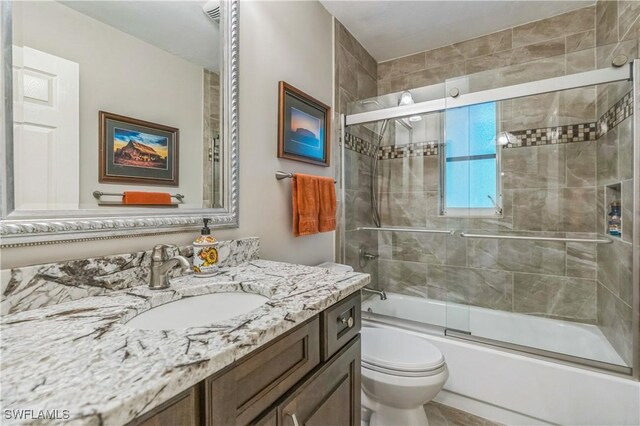 1440 14th Ave NE, Naples, FL 34120 - bathroom featuring vanity and enclosed tub / shower combo