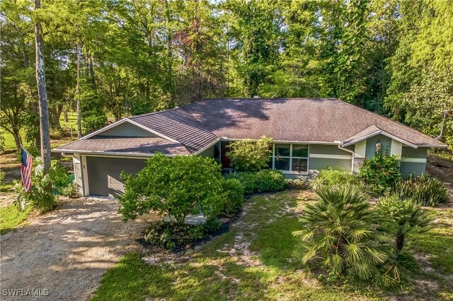 1440 14th Ave NE, Naples, FL 34120 - ranch-style house with dirt driveway and stucco siding