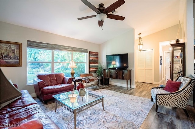1440 14th Ave NE, Naples, FL 34120 - living area featuring vaulted ceiling, ceiling fan, and wood finished floors
