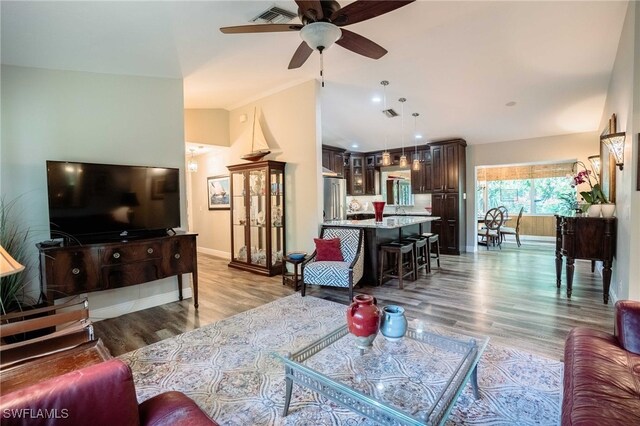 1440 14th Ave NE, Naples, FL 34120 - living room featuring a ceiling fan, wood finished floors, and vaulted ceiling