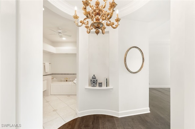 3051 Lancaster Dr Unit 4, Naples, FL 34105 - corridor featuring a raised ceiling, a chandelier, crown molding, light wood finished floors, and baseboards