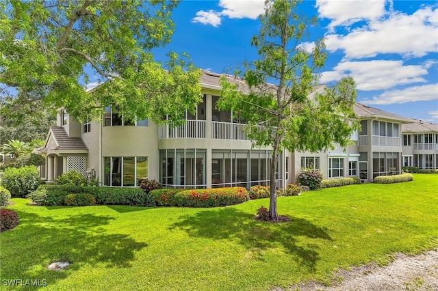 3051 Lancaster Dr Unit 4, Naples, FL 34105 - rear view of house featuring stucco siding and a yard
