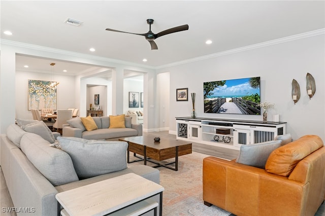 living room featuring recessed lighting, ceiling fan, crown molding, and light wood finished floors