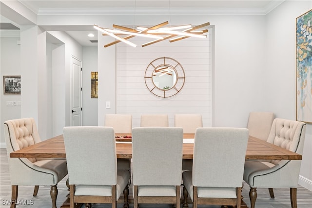 dining area featuring wood finished floors, crown molding, recessed lighting, and a chandelier